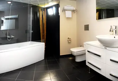 a bathroom with a tub and a sink and a toilet at Tempo Hotel Caglayan in Istanbul