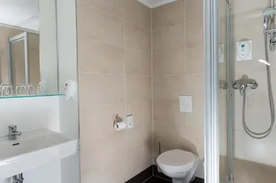 a bathroom with a shower and a toilet and a sink at SUFI APART Otel in Istanbul