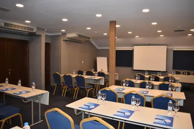 a conference room with tables and chairs and a whiteboard at Rhiss Hotel Bostanci in Istanbul
