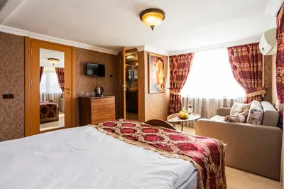 a hotel room with a bed and a couch at The First Ottoman Suites in Istanbul