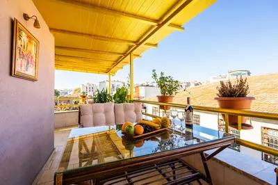 a balcony with a glass table with fruit on it at The First Ottoman Suites in Istanbul