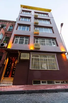 a tall building with many windows on a street at The First Ottoman Suites in Istanbul