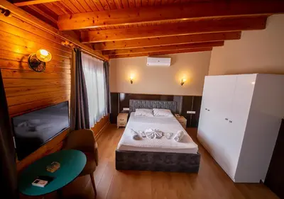 a bedroom with a bed and a tv in it at Royal Garden Suite and Hotel in Istanbul