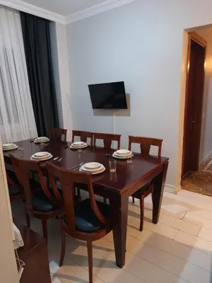 a dining room with a wooden table and chairs at Royal Garden Suite and Hotel in Istanbul