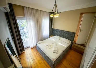 a bedroom with a bed with a towel on it at Royal Garden Suite and Hotel in Istanbul