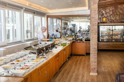 a chef preparing food in a restaurant kitchen at Baron Hotel & Spa in Istanbul