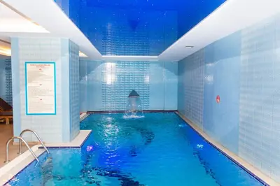 a large swimming pool with blue tiled walls at Baron Hotel & Spa in Istanbul