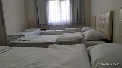 a group of beds in a room with a window at Marpalace Hotel in Istanbul