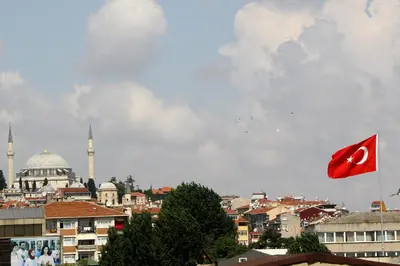 a red flag flying over a city with a mosque at Marpalace Hotel in Istanbul