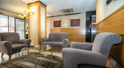 a waiting room with chairs and a glass table at My Rose Hotel in Istanbul