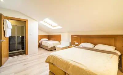 a hotel room with two beds and a window at My Rose Hotel in Istanbul