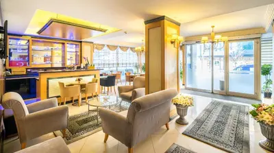 a living room with a bar and a dining room at My Rose Hotel in Istanbul