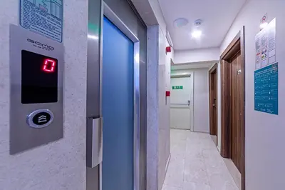 a hospital hallway with a door with a clock on the wall at Septimum in Istanbul