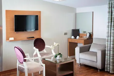 a living room with a couch and a chair at Sorriso Hotel in Istanbul
