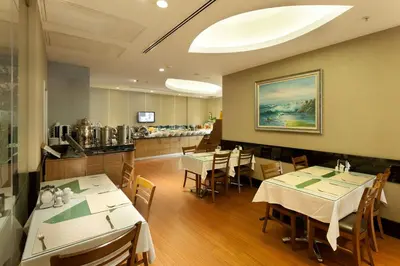 a restaurant with tables and chairs and a counter at Sorriso Hotel in Istanbul