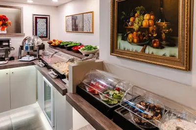 a kitchen with a painting of fruits and vegetables at Cheya Beşiktaş Istanbul Bosphorus City Center Hotel & Suites in Istanbul