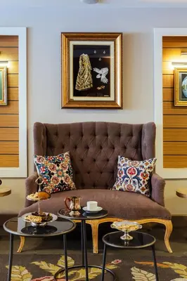 a living room with a couch and two tables at Cheya Beşiktaş Istanbul Bosphorus City Center Hotel & Suites in Istanbul