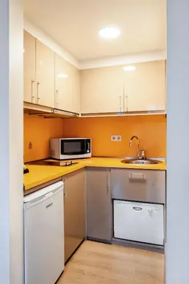 a small kitchen with a sink and a microwave at Cheya Beşiktaş Istanbul Bosphorus City Center Hotel & Suites in Istanbul