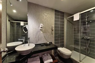 a bathroom with two sinks and a shower at Tiara Thermal & SPA Hotel in Bursa