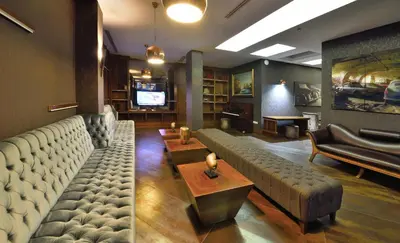 a living room with a couch and a television at Tiara Thermal & SPA Hotel in Bursa