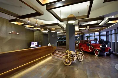 a room with a motorcycle and an old car in it at Tiara Thermal & SPA Hotel in Bursa