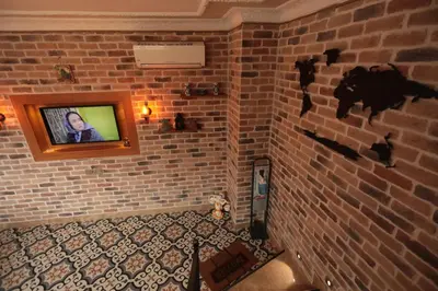 a room with a brick wall with a television on it at White Pearl Apart Hotel in Istanbul