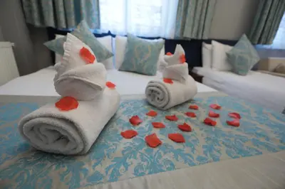 a bed with towels and hearts on the bed at White Pearl Apart Hotel in Istanbul