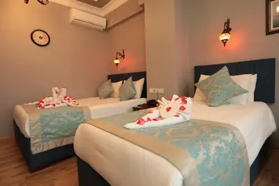 a hotel room with two beds with towels on them at White Pearl Apart Hotel in Istanbul