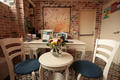 a table and chairs with a vase of flowers on it at White Pearl Apart Hotel in Istanbul