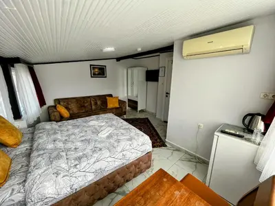a bedroom with a bed and a couch at Pembe Hotel in Istanbul