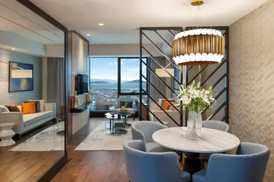 a living room with a table and blue chairs at Elite World Grand Istanbul Küçükyalı in Istanbul