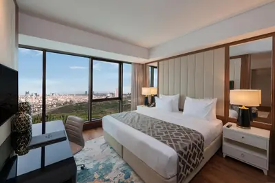 a hotel room with a bed and a large window at Elite World Grand Istanbul Küçükyalı in Istanbul