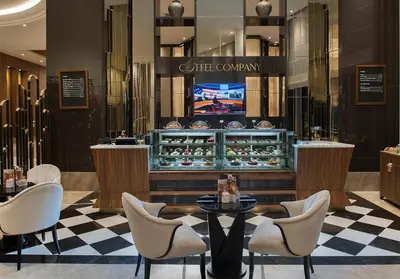 a restaurant with a counter with chairs and a table at Elite World Grand Istanbul Küçükyalı in Istanbul