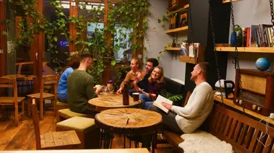 a group of people sitting around a table in a room at Stay Inn Taksim Hostel in Istanbul