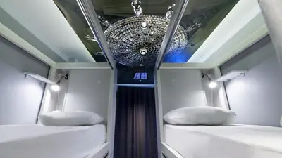 a room with two beds and a chandelier at Stay Inn Taksim Hostel in Istanbul