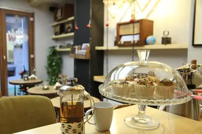 a glass dish of cupcakes on top of a table at Stay Inn Taksim Hostel in Istanbul