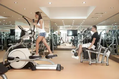 a man and a woman exercising in a gym at Mercia Hotels & Resorts in Buyukcekmece