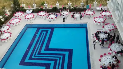 an overhead view of a pool with tables and chairs at Mercia Hotels & Resorts in Buyukcekmece