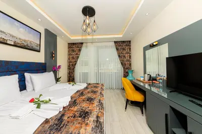 a hotel room with a bed and a desk at The Magnaura Palace Hotel in Istanbul