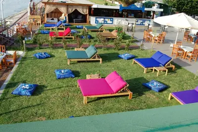 a group of chairs sitting on the grass at Grand Koru Hotel Beach in Yalova