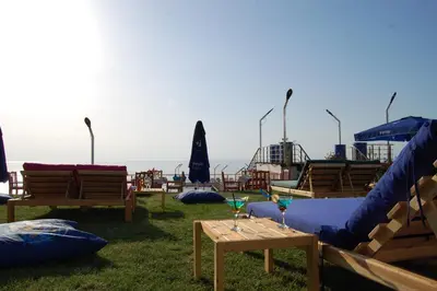 a group of chairs and tables with drinks on them at Grand Koru Hotel Beach in Yalova