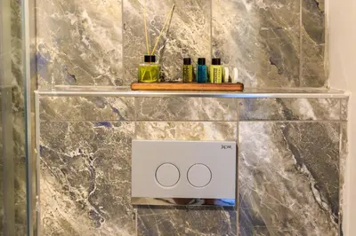 a bathroom with a scale with two bottles on it at Nar Palace in Istanbul