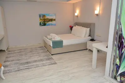 a small bedroom with a bed and a table at Nar Palace in Istanbul
