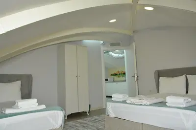 a bedroom with two beds and a mirror at Nar Palace in Istanbul