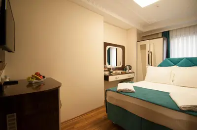 a hotel room with a bed and a mirror at Akbiyik Suite Boutique Hotel in Istanbul
