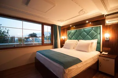 a bedroom with a large bed with a large window at Akbiyik Suite Boutique Hotel in Istanbul