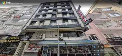 a tall building with a sign in front of it at Moon Suit Hotel in Istanbul