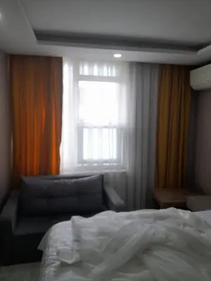 a bedroom with a bed and a window and a couch at Moon Suit Hotel in Istanbul