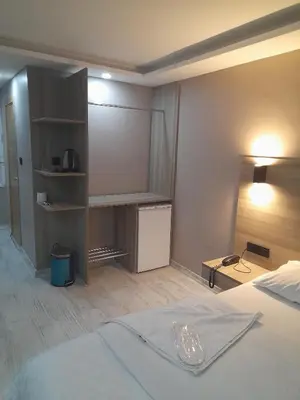 a hotel room with a bed and a book shelf at Moon Suit Hotel in Istanbul