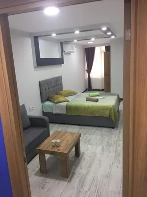 a bedroom with a bed and a couch and a table at Moon Suit Hotel in Istanbul